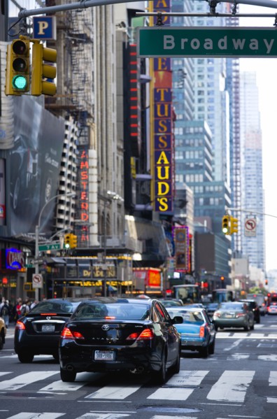 USA, New York, New York City, Manhattan  Cars crossing Broadway at green traffic lights travelling