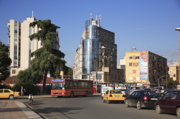 Albania, Tirane, Tirana, Busy street scene with bus in traffc.