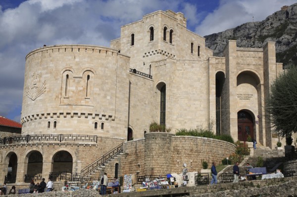 Albania, Kruja, Kruja Castle and Skanderbeg Museum exterior with tourist visitors and souvenir