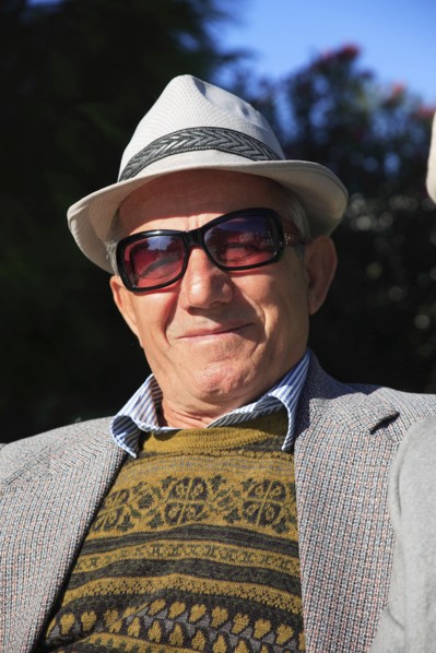 Albania, Tirane, Tirana, Head and shoulders full face portrait of a middle-aged man wearing a hat