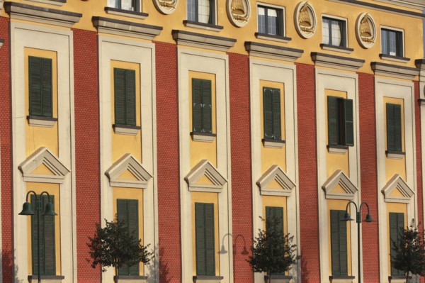 Albania, Tirane, Tirana, Detail of red and yellow exterior facade of government buildings on