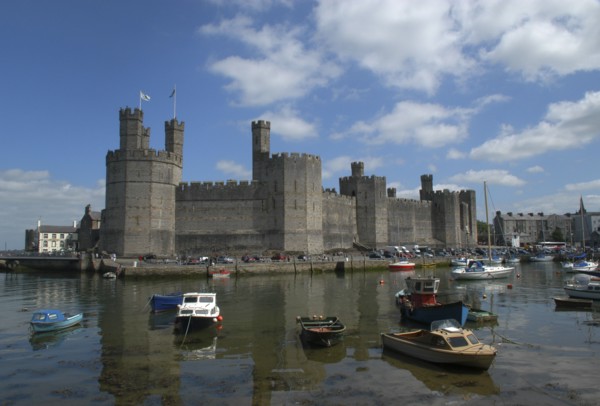 Wales, Gwynedd, Conway, Conway Castle seen over moored boats in the harbour