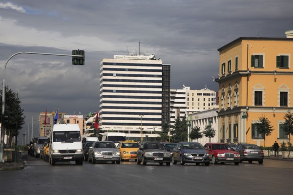 Albania, Tirane, Tirana, Traffic waiting at lights in Skanderbeg Square in front of the Tirana
