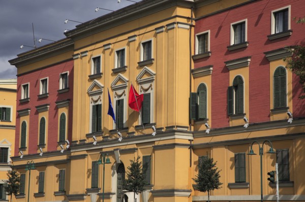 Albania, Tirane, Tirana, Pink and yellow exterior facades of government buildings on Skanderbeg