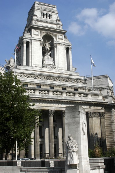 England, London, Memorial statue of a soldier with architecture behind