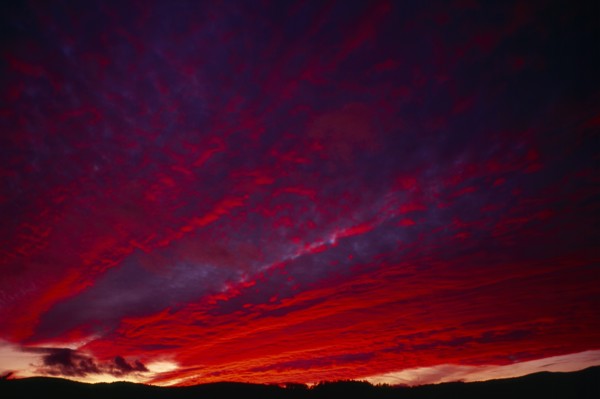 England, Climate, Sunset, Narrow  strip of land silhouetted against dramatic sunset sky with clouds