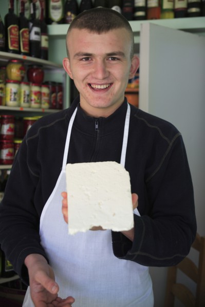 Albania, Tirane, Tirana, Young male cheese shop vendor in the Avni Rustemi Market wearing white