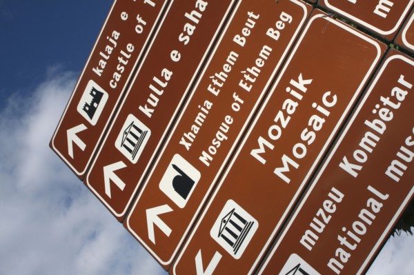 Albania, Tirane, Tirana, Street sign giving directions to places of interest.