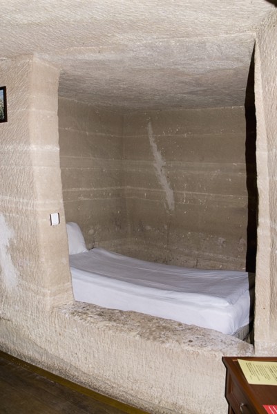 Room with bed in typical cave hotel carved out of volcanic tufa rock. Photo: Hugh Rooney