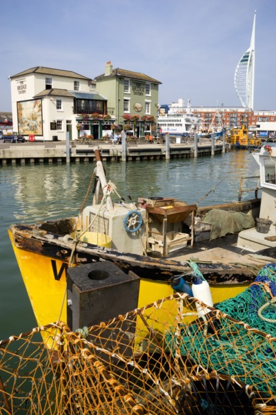 The Camber in Old Portsmouth showing the Spinnaker Tower behind the Bridge Tavern with its mural of