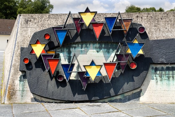 Dachau World War II Nazi Concentration Camp. Prisoner badges memorial Communists were given red