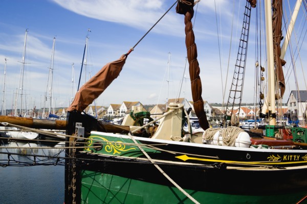 Port Solent Sailing barge SB Kitty moored in the marina with housing beyond. Photo: Paul Seheult