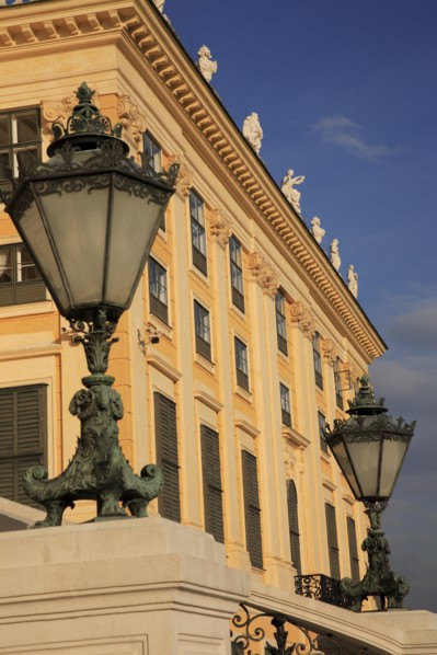Schonnbrunn Palace. Part view of exterior facade with decorative metal lanterns on balcony in