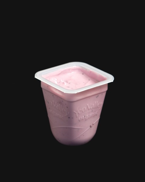 Yeo Valley probiotic blueberry fruit yogurt pot against a black background. Photo: Paul Seheult