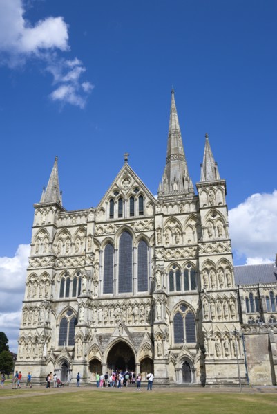 People on the grass of the Close in front of the West Front main entrance of the 13th Century Early