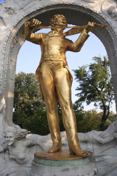 Statue of Johann Strauss in the Stadt Park framed by stone arch. Photo: Bennett Dean