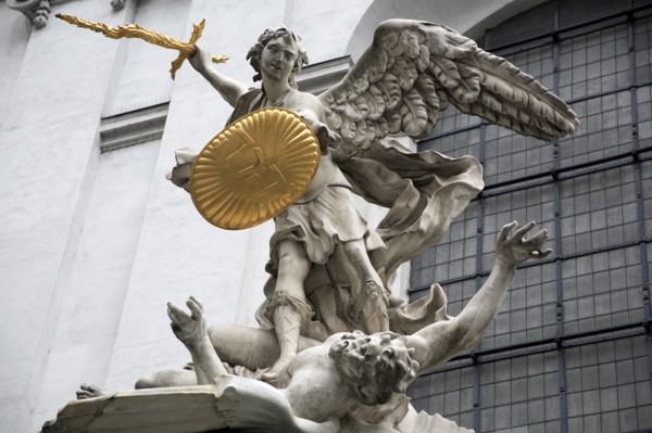 Sculpted figures above the entrance to St Michaels Church depicting St Michael slaying Lucifer by