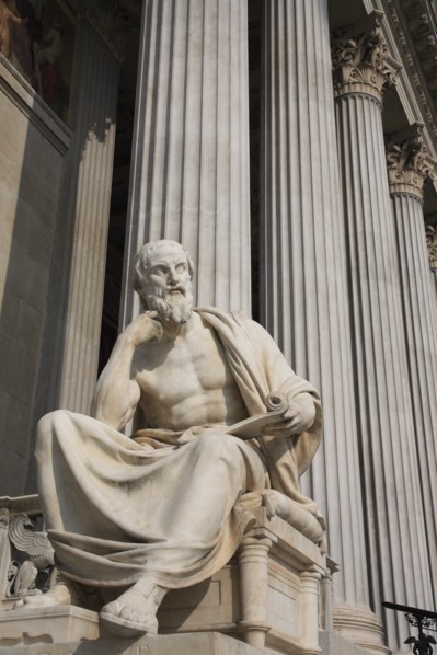 Statue of the Greek philosopher Herodotus in front of columns of the Parliament Building. Photo: