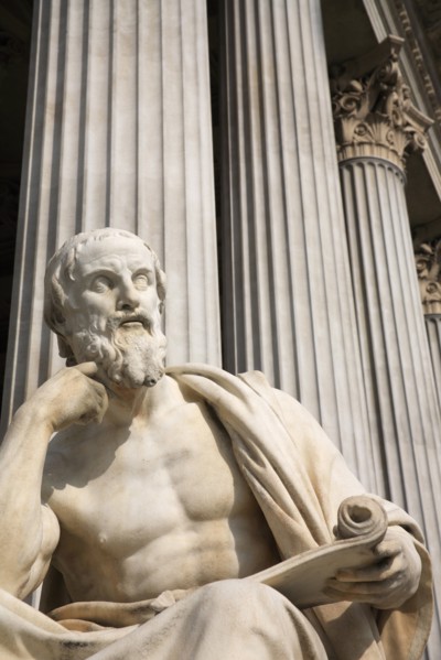 Statue of the Greek philosopher Herodotus in front of columns of the Parliament Building. Photo: