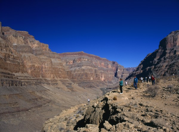 USA, Arizona, Grand Canyon, Tourists looking down onto the colorado river from within the Hualapai