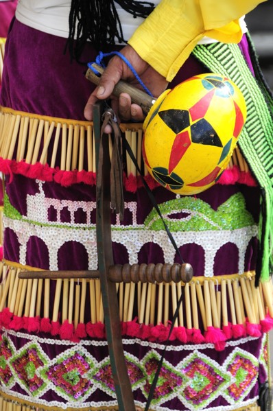 Mexico, Bajio, Zacatecas, Indigenous dance group detail of dress and musical instrument. 
Photo :