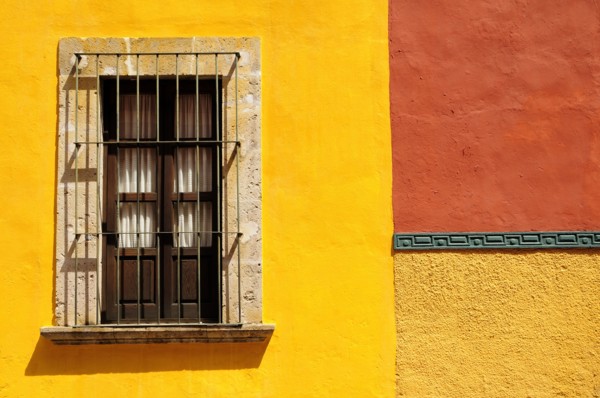Mexico, Bajio, San Miguel de Allende, Detail of exterior wall of bright yellow and orange painted