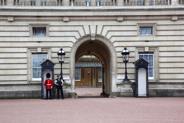 England, London, Westminster Buckingham Palace exterior with both Queens Guard and Metropolitan