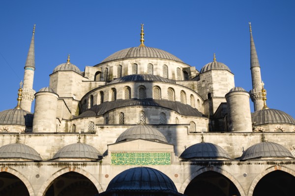 Turkey, Istanbul, Sultanahmet Camii The Blue Mosque domes seen from the Courtyard with Arabic text