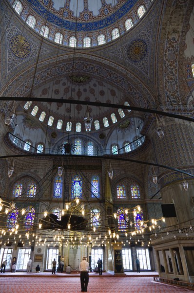 Turkey, Istanbul, Sultanahmet Camii The Blue Mosque interior with people at prayer beneath