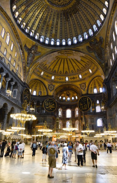 Turkey, Istanbul, Sultanahmet Haghia Sophia Sightseeing tourists beneath the dome with murals and