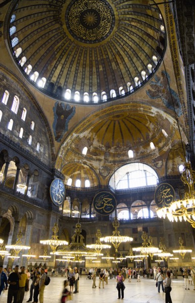 Turkey, Istanbul, Sultanahmet Haghia Sophia Sightseeing tourists beneath the dome with murals and