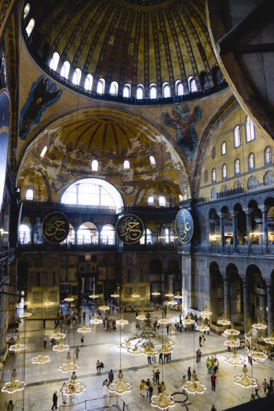 Turkey, Istanbul, Sultanahmet Haghia Sophia Sightseeing tourists beneath the dome with murals and