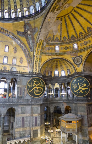 Turkey, Istanbul, Sultanahmet Haghia Sophia Sighseeing tourists beneath the dome with murals and