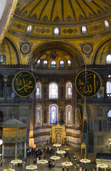 Turkey, Istanbul, Sultanahmet Haghia Sophia Sightseeing tourists beneath the dome with murals and