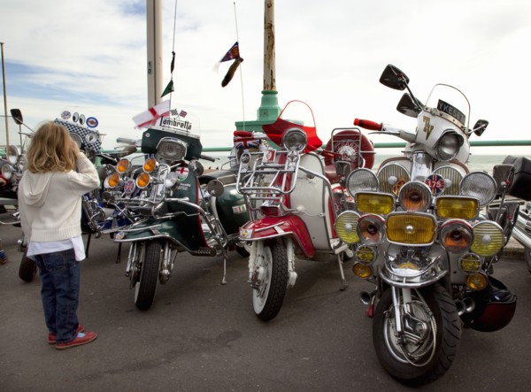 Elaborately decorated Mopeds on Madeira Drive during motorbike festival.
