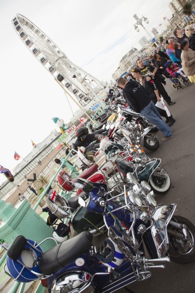 Elaborately decorated Mopeds on Madeira Drive during motorbike festival.