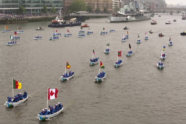 Flotilla of Sea Cadets in small boats proceeds along River Thames past HMS Belfast as part of the Queens Thames Diamond Jubilee Pageant taken from Tower Bridge 3rd June 2012.