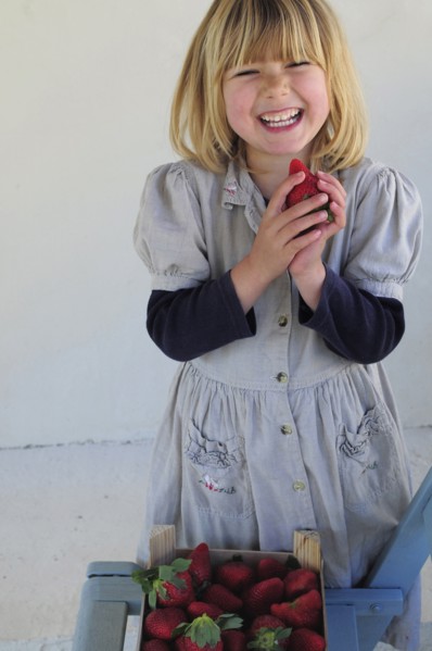 5 year old Eva eating first strawberries of the year in February.