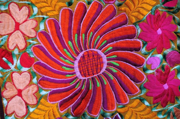 Mexico, Bajio, San Miguel de Allende, Detail of brightly embroidered textile in arts shop with