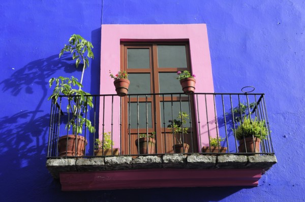 Mexico, Puebla, Colourful architectural detail of French window with pink painted frame set against