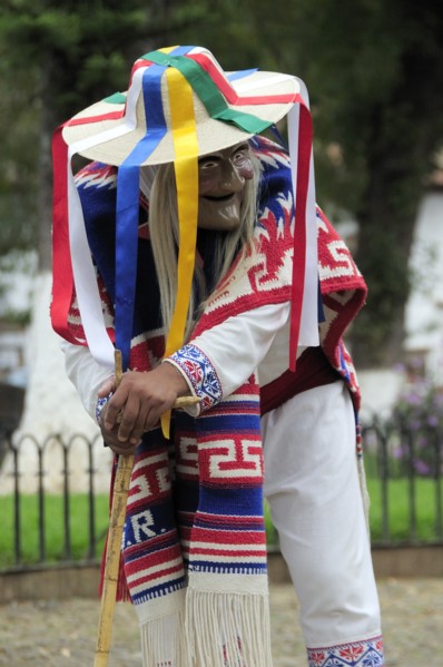 Mexico, Michoacan, Patzcuaro, Figure wearing mask and costume performing Danza de los Viejitos or