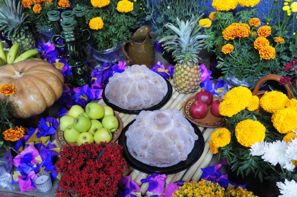 Mexico, Michoacan, Patzcuaro, Altar with display of food and flowers including marigolds for Dia de