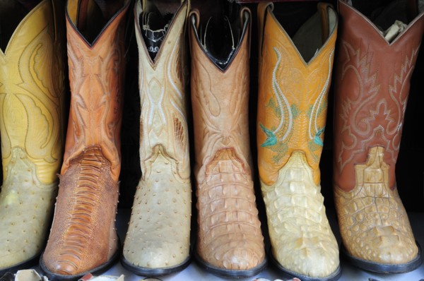 Mexico, Jalisco, Guadalajara, Line of embroidered leather boots for sale. Photo : Nick Bonetti