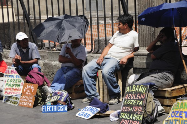 Mexico, Federal District, Mexico City, Workers plying trade outside the Cathedral in the Zocalo