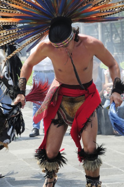 Mexico, Federal District, Mexico City, Michacoa Aztec dancer wearing brightly coloured feather