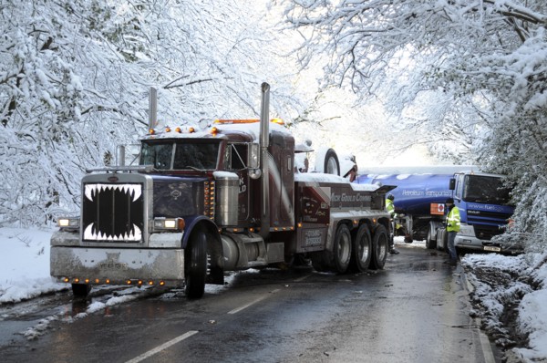 Weather, Winter, Snow, Recovery truck extracting a Jack-knifed fuel tanker on icy A22 main road