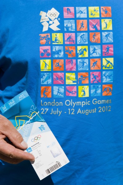 England, London, An Olympic spectator wearing an official T-shirt holding their official ticket for
