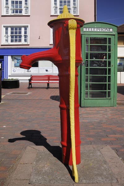 Ireland, County Cork, Kinsale, Colourful old water pump and telephone box. Photo : Hugh Rooney