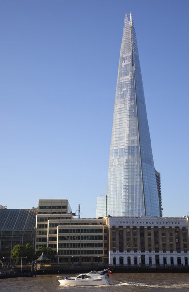 England, London, Southwark southbank Pleasure boat passing the Shard skyscraper designed by Renzo