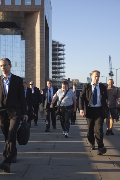 England, London, Early morning commuters crossing London Bridge towards the City Financial district